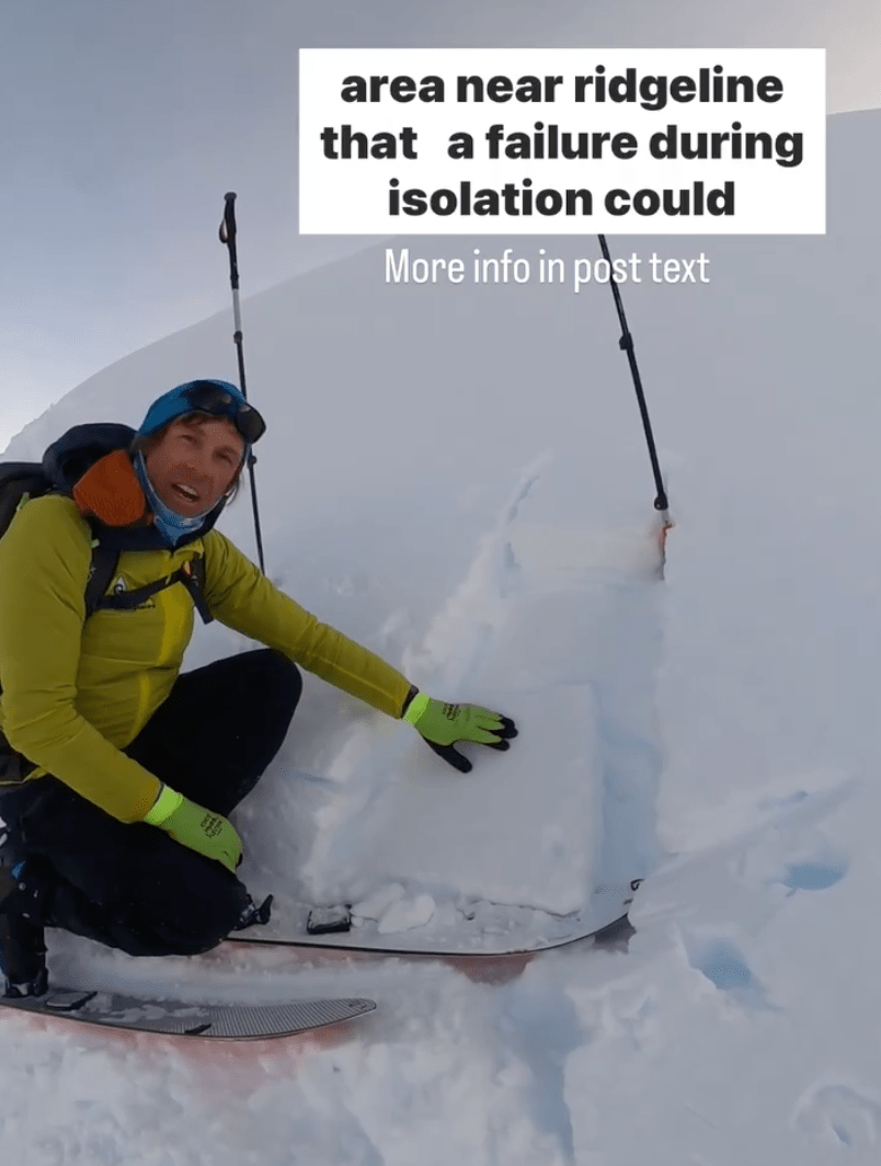 a progessional ski guide shows layers in a windslab hand pit