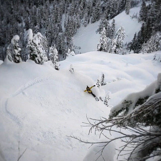 a splitboarder makes a toe side turn slash with a ski guide from guided exposure at mt baker wa seattle wa north cascades