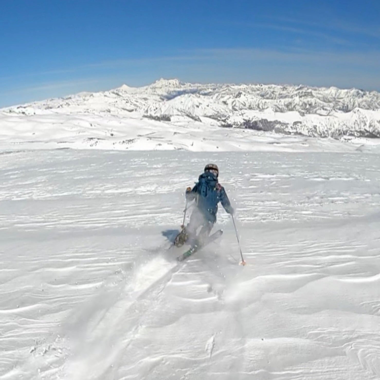 A skier makes turns while backcountry skiing with a guide on Volcan Nevados de Chillan