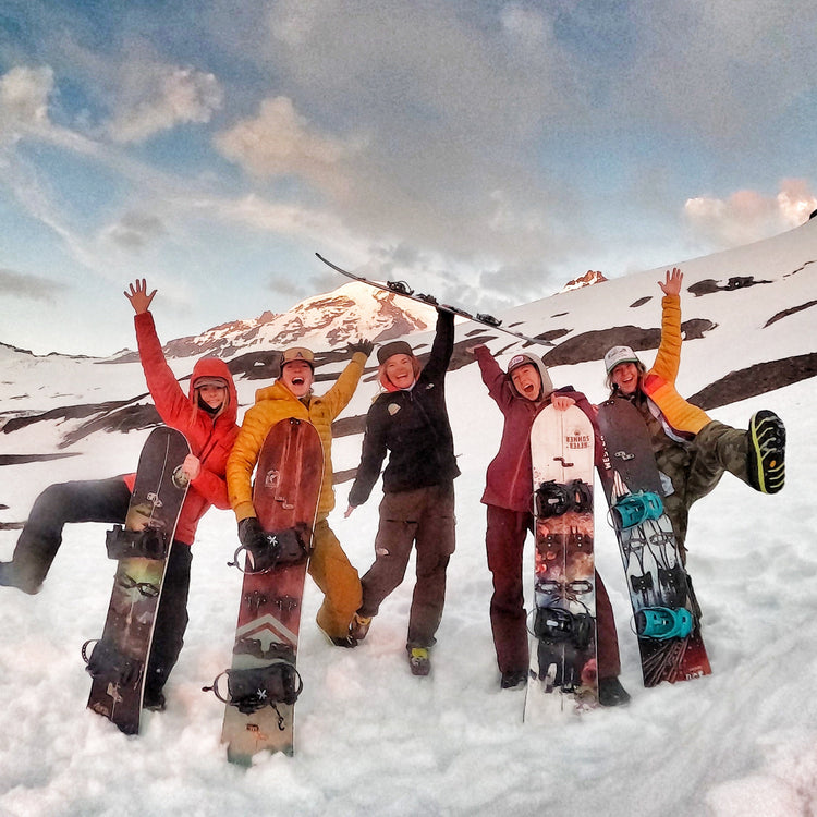 a group of splitboarding women cheering during sunset with hands in the air during guided exposures women splitboard mountaineering camp