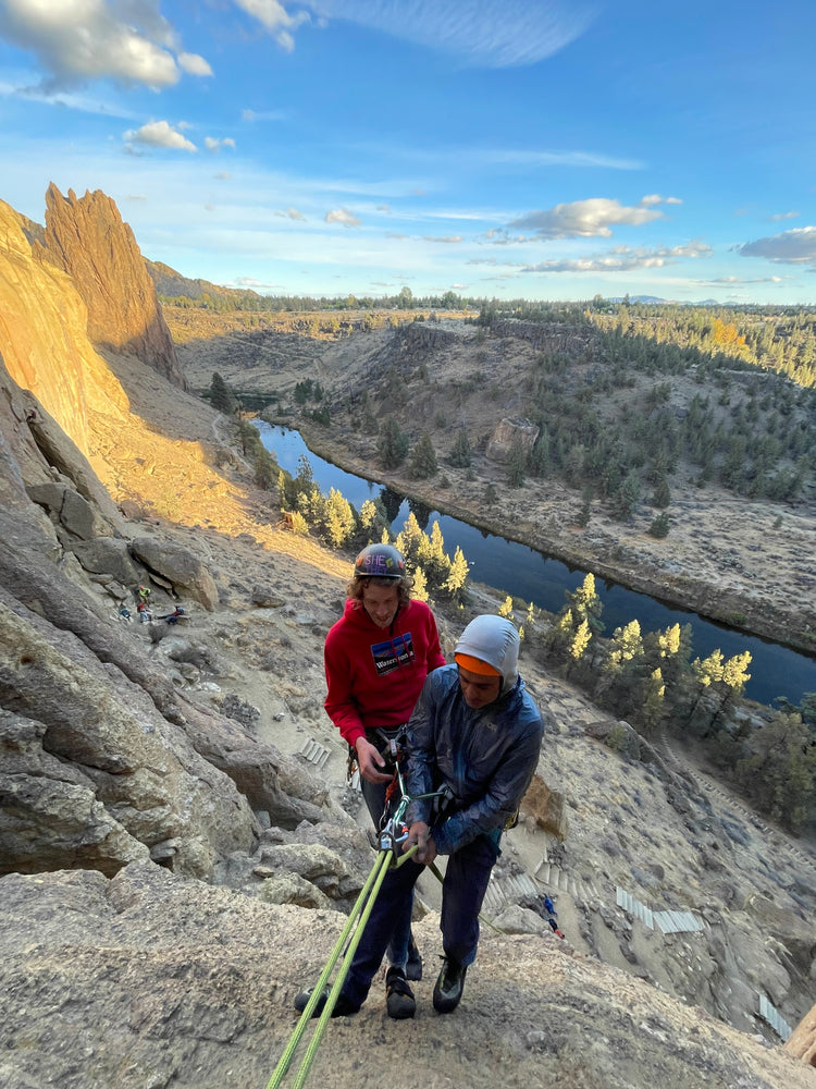 Trad climber placing gear on a multi-pitch rock route during a climbing and rescue seminar in Washington