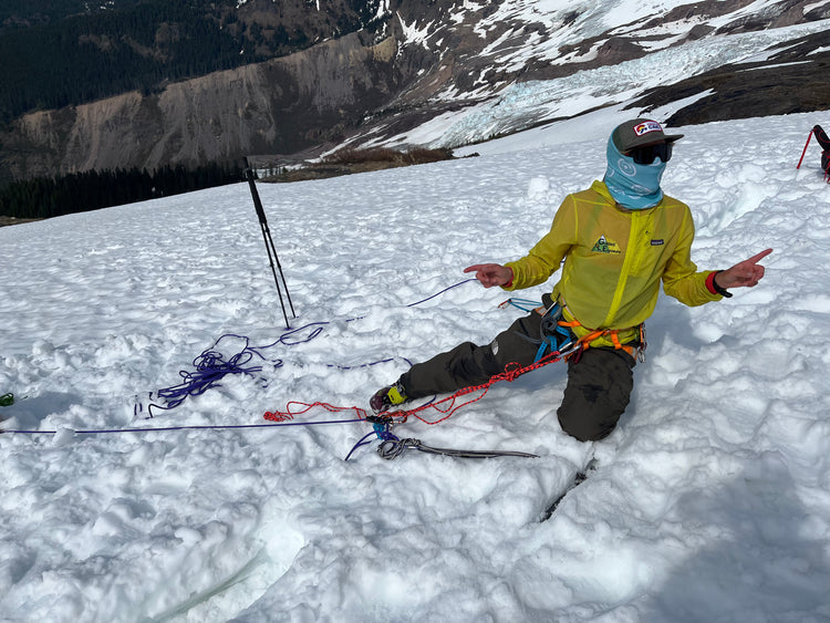 Splitboard guide teaches snow anchors and crevasse rescue during a womens splitboard mountaineering course