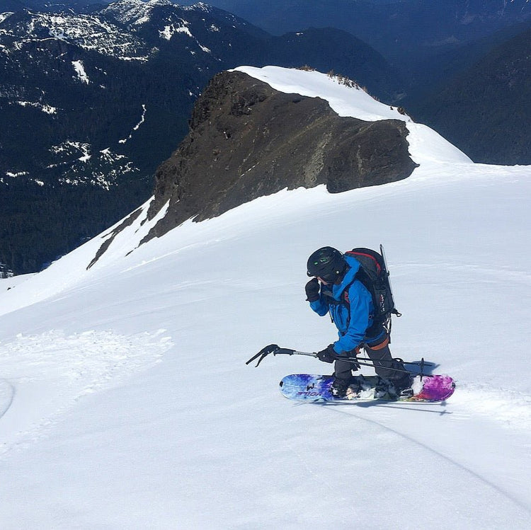 A woman makes splitboard turns on mt baker in the springtime on spring corn snow