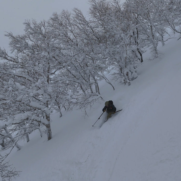 a skier riding deep blower japow during a trip with a ski guide