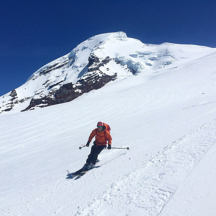 A skier enjoys sunshine and soft turns on the Coleman Glacier of Mount Baker.