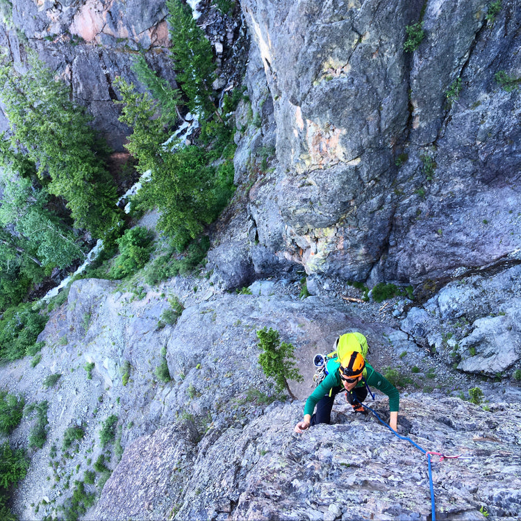 the 1st pitch of the rock climb fly boys in mazama wa. A rock climber moves high above the gate creek waterfall below