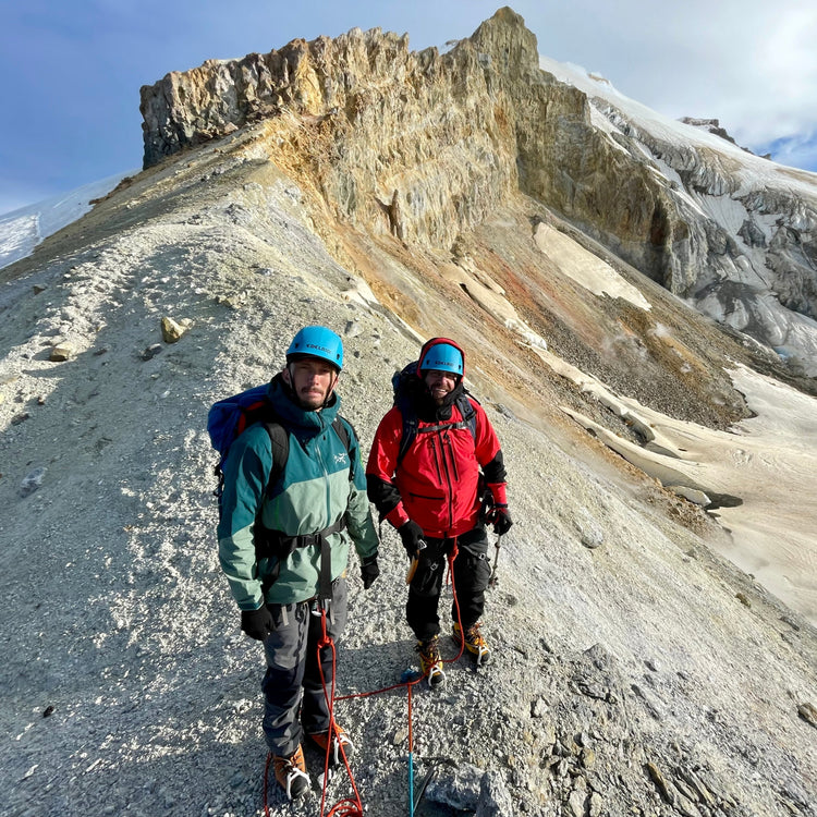 Standing on the Sherman crater on Mount Baker, Steam from the fumaroles rises towards the Boulder and Shquak glaciesr that hangs in the background.