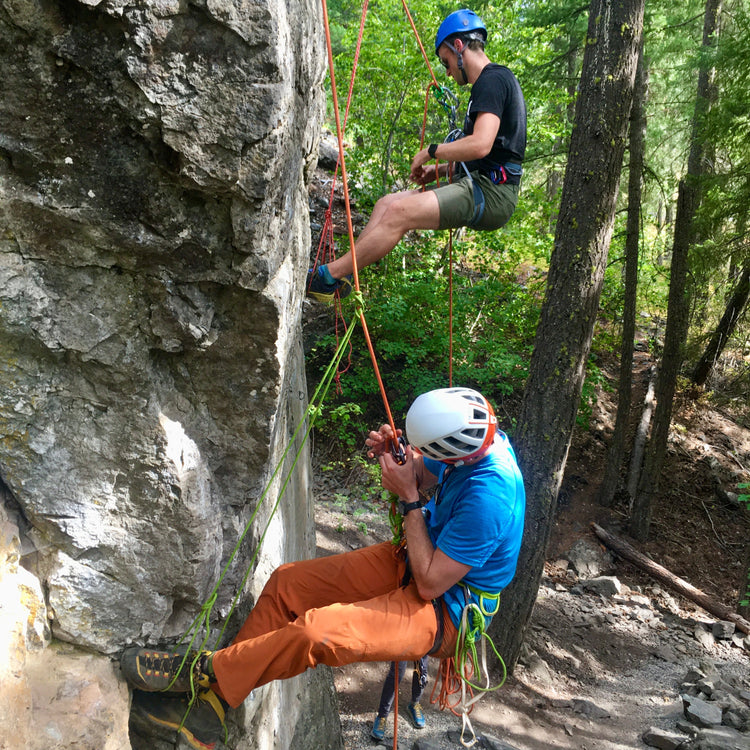 rock climbers ascend ropes using foot prussiks during a rock rescue course with guided exposure in mazama washington