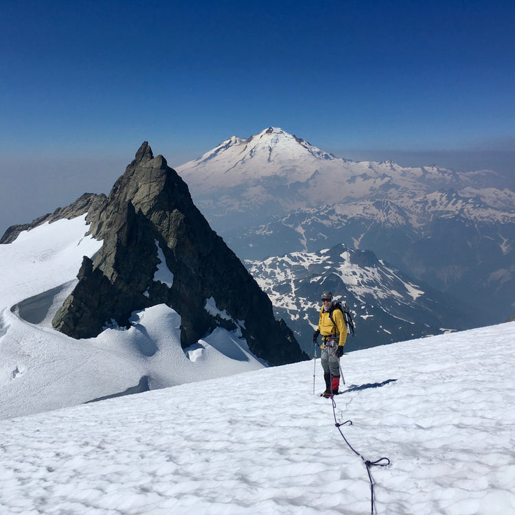 on the mt shuksan sulphide glacier with mt baker in the background