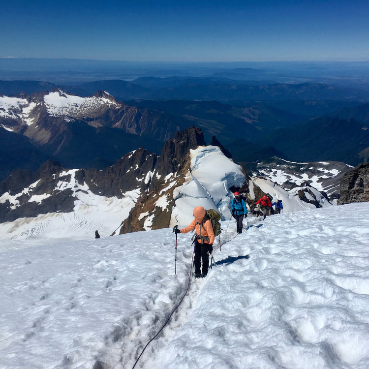 A guided trip nears the summit of Mount Baker while views of Colfax, the Twin Sisters, and the Puget Sound are below.