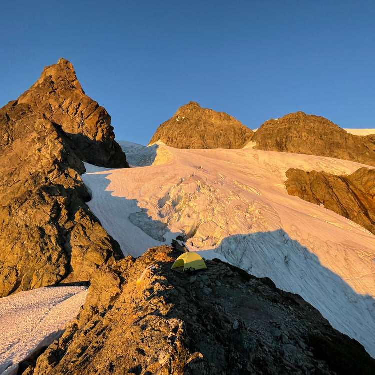 winnie slide bivy on the white salmon glacier with the upper curtis glacier and shuksan summit pyramid in sunset alpenglow