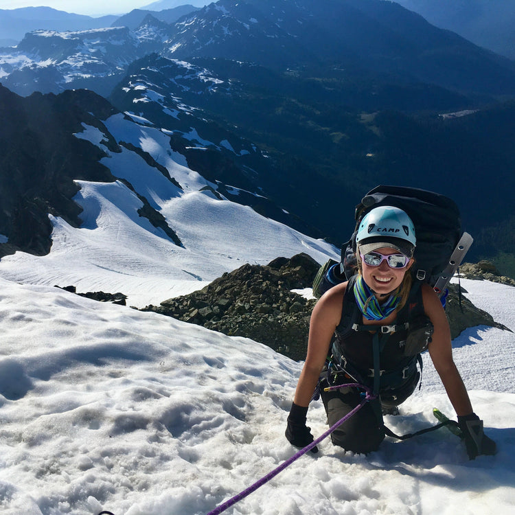 a mountaineer using an ice axe climbing up winnies slide on the white salmon lacier on mt shuksan in the north cascades