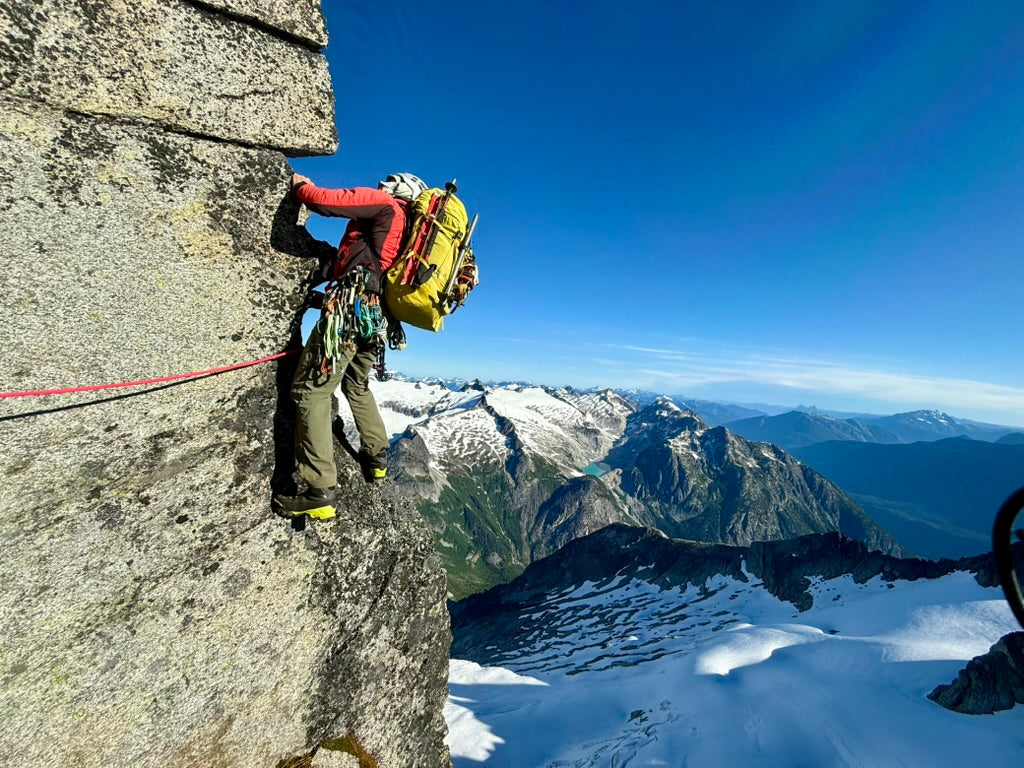 climbing the north ridge of forbidden peak above the glacier in north cascades