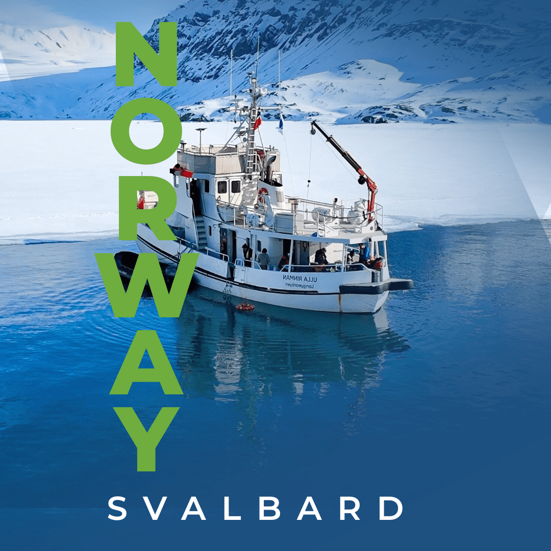 Ski tourers climbing a snowy Arctic peak above a glacier in Svalbard, Norway
