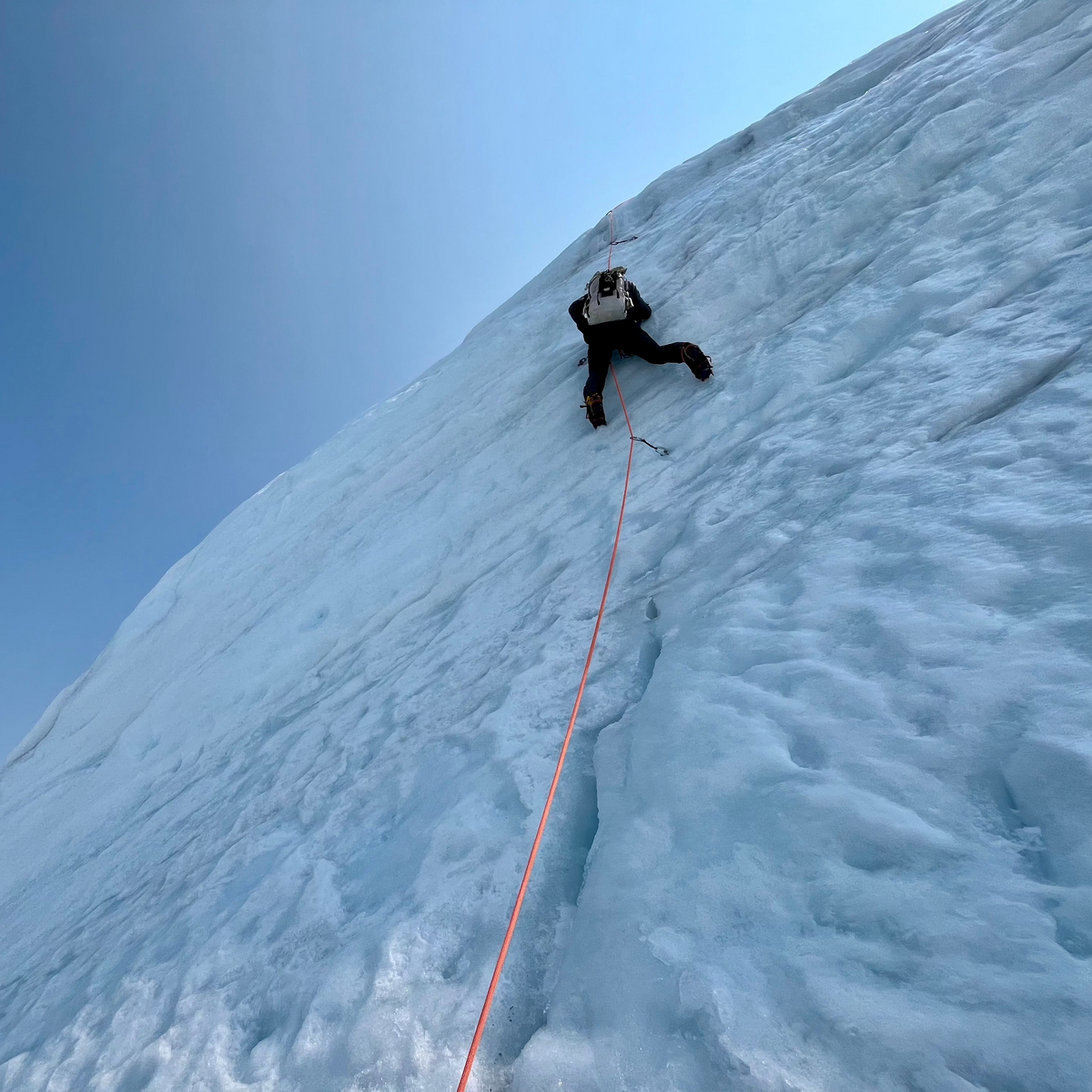 a mountain guide leads ice climbing pitch on mount baker north ridge during the summer