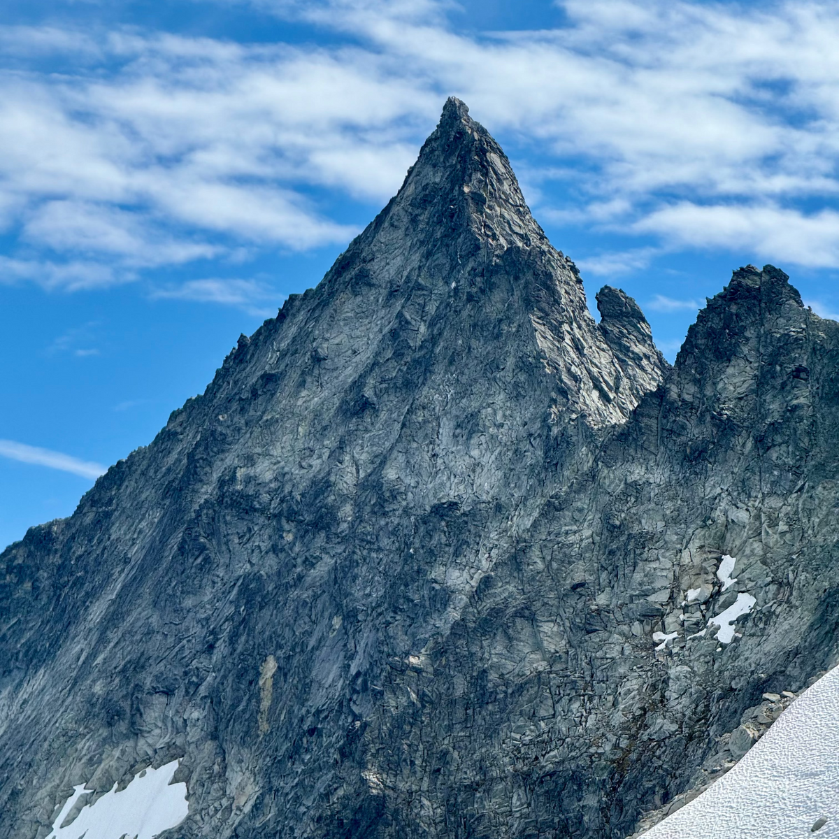 Tall, rugged mountain peak with a clear blue sky