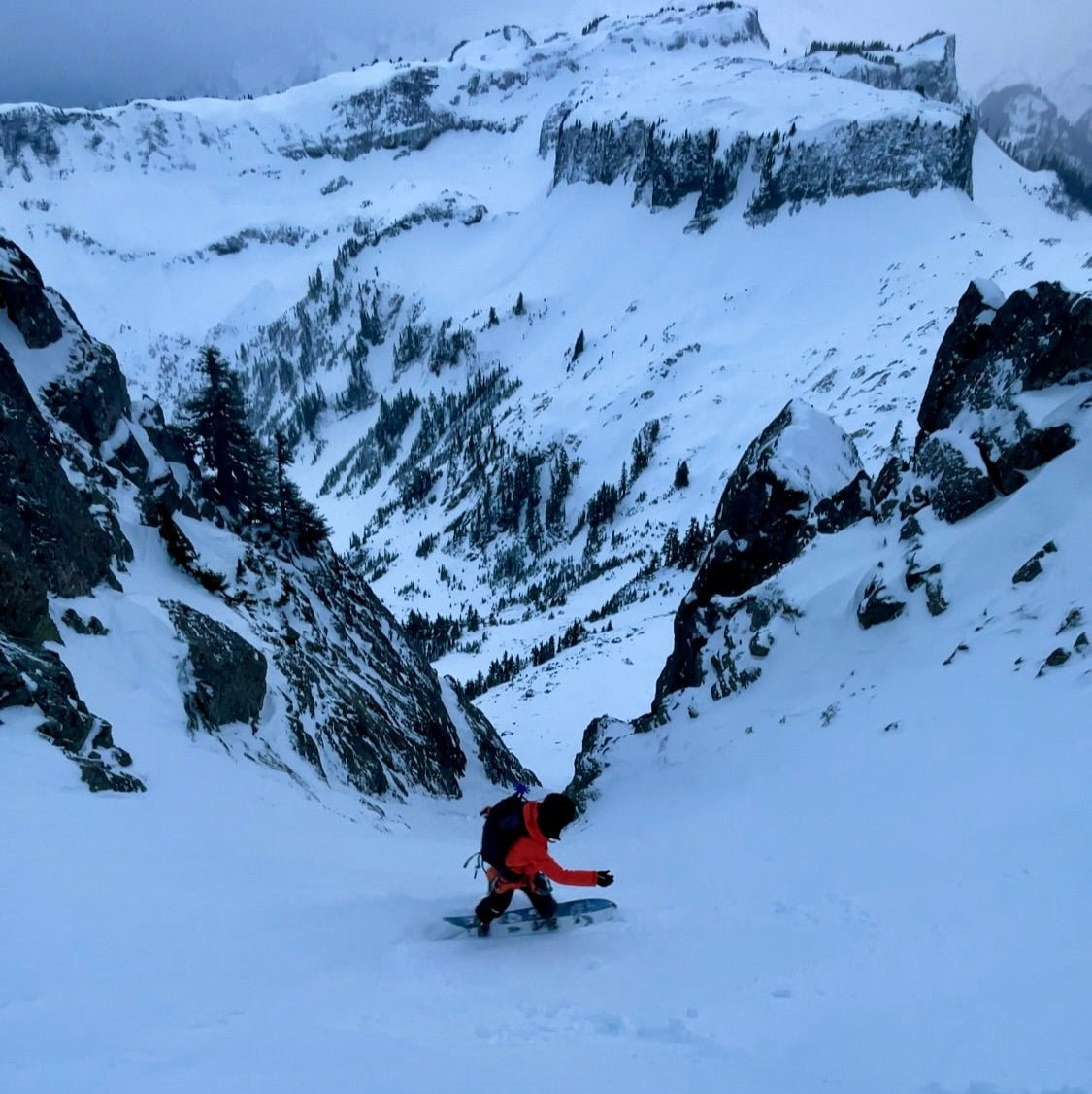 woman splitboarding in couloir