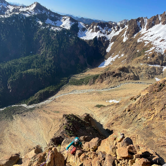 an alpine climber above green creek in the twin sisters range near mt baker wa