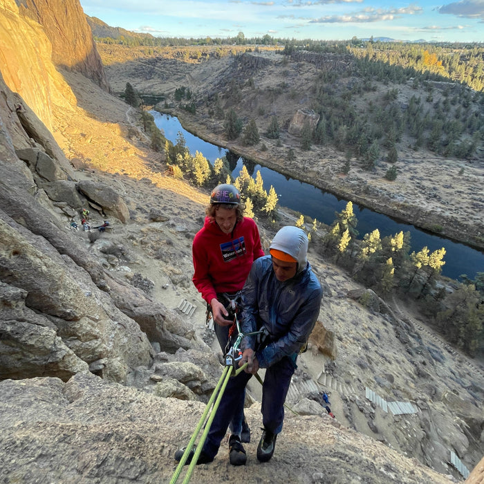 Trad climber placing gear on a multi-pitch rock route during a climbing and rescue seminar in Washington