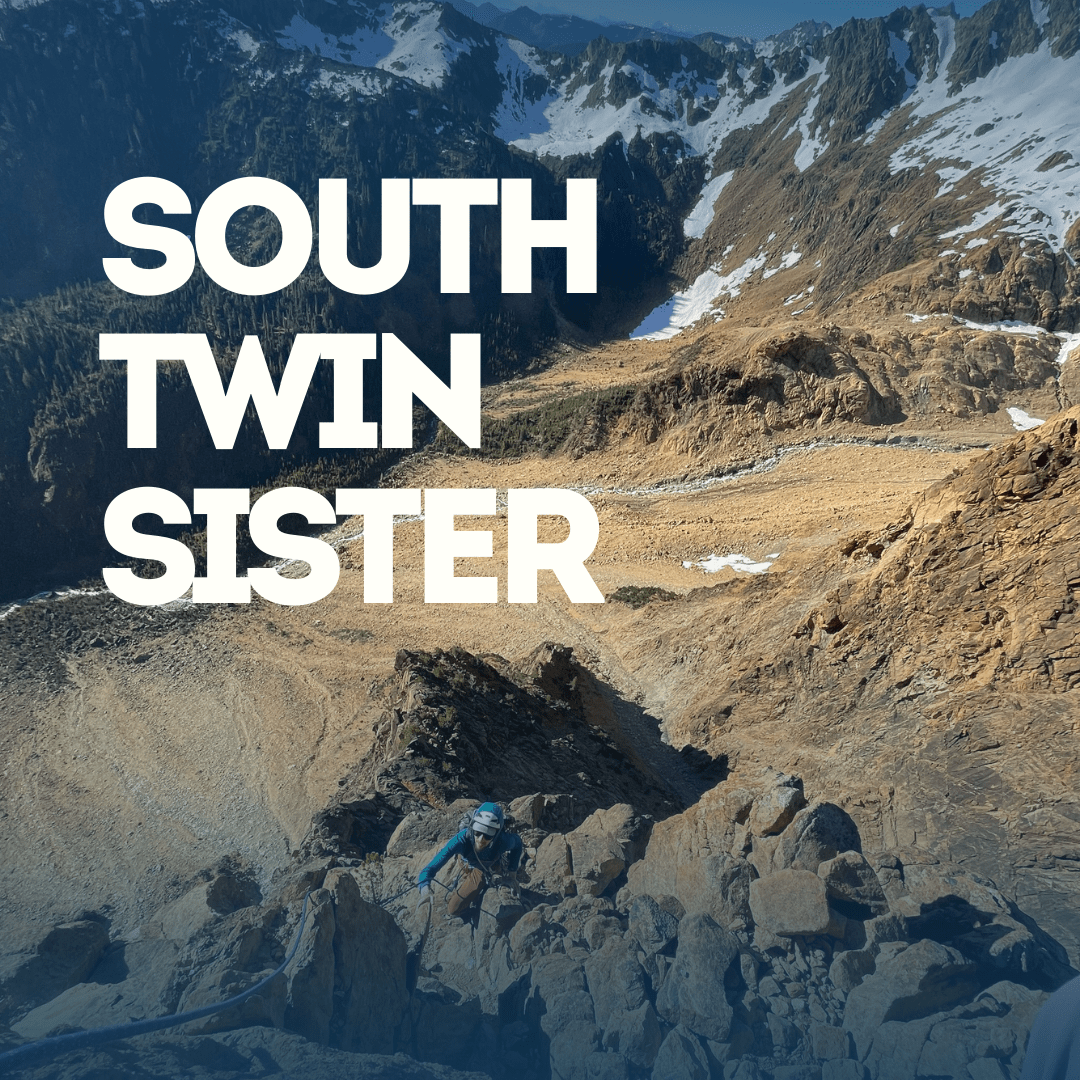Person climbing a rocky mountain with South Twin Sister