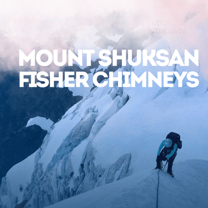 Person climbing a snowy mountain with Mount Shuksan Fisher Chimneys
