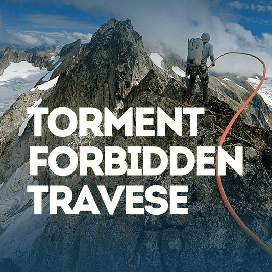 Person on a mountain peak with Torment Forbidden Traverse and a red rope