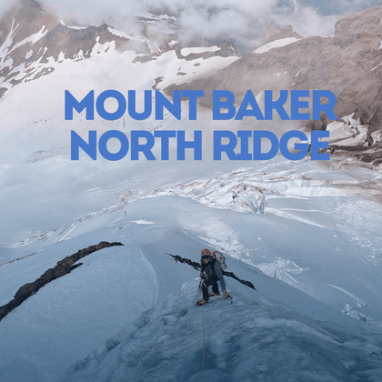 Person on a snowy mountain ridge with Mount Baker North Ridge