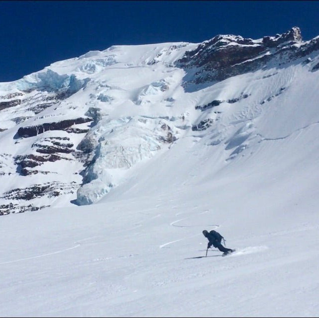 Splitboarder enjoying some low angle turns after riding steeps on Mount Baker.