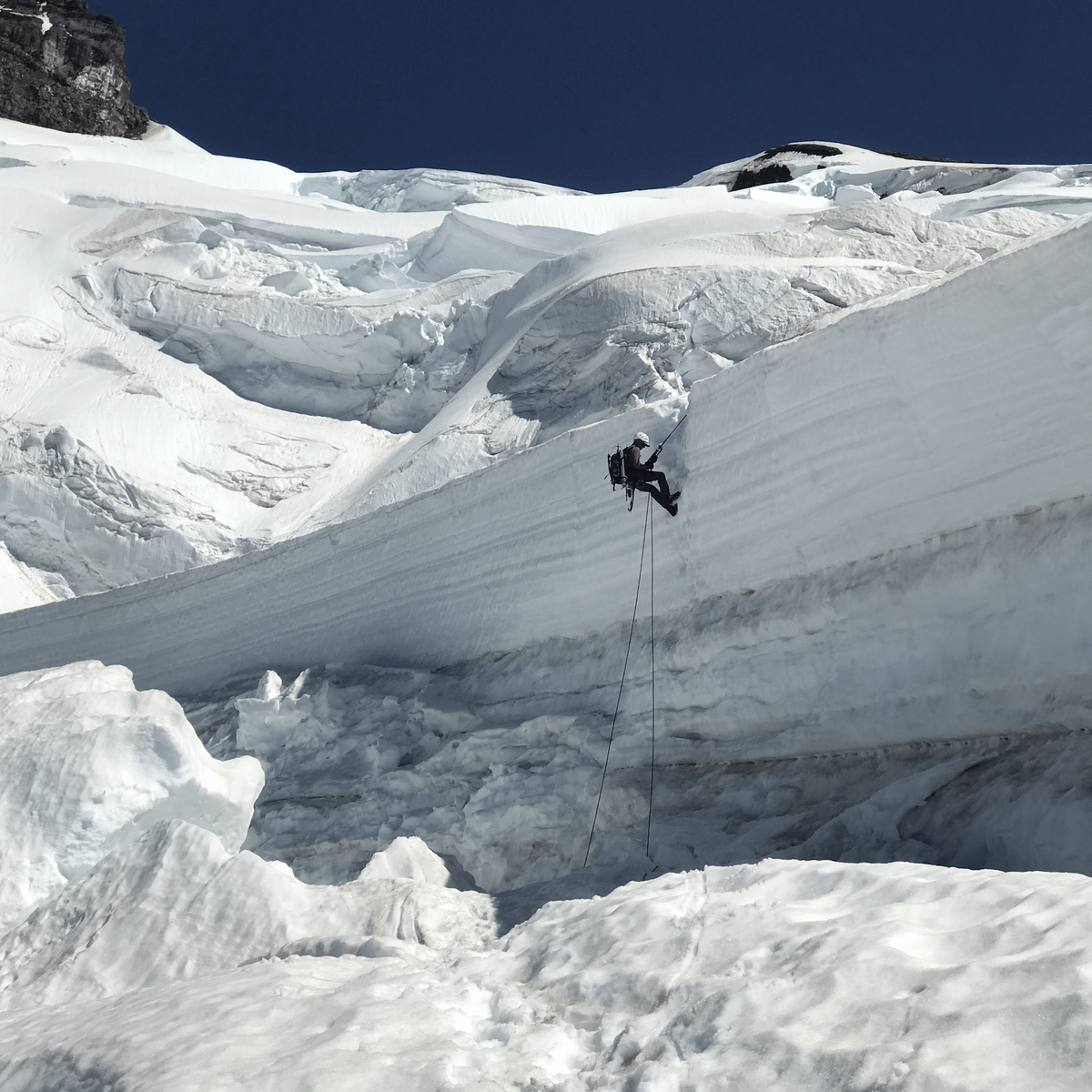 technical descent over a bergscrund on the coleman glacier while descending from the north ridge of mount baker
