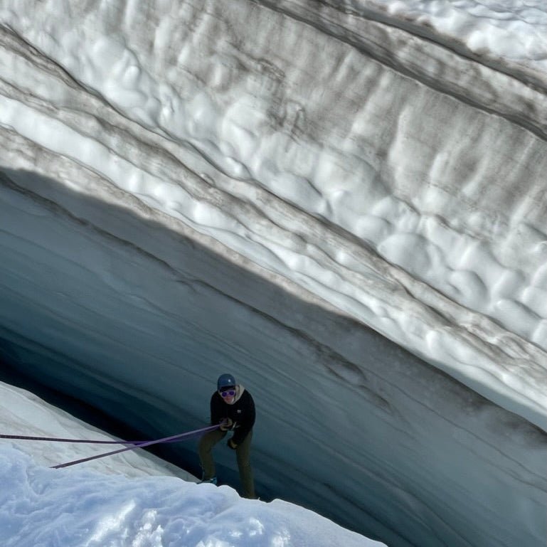 A climber at the edge of a crevasse on the glacier during a Glacier Travel Course at Mount Baker