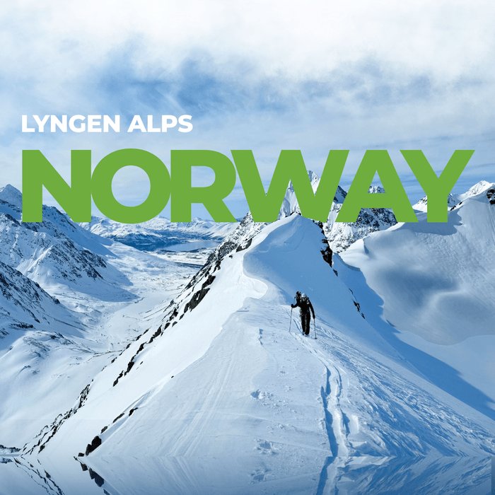 Guided Lyngen Alps ski trip — a ski tourer skins a ridge above the fjords of Arctic Norway