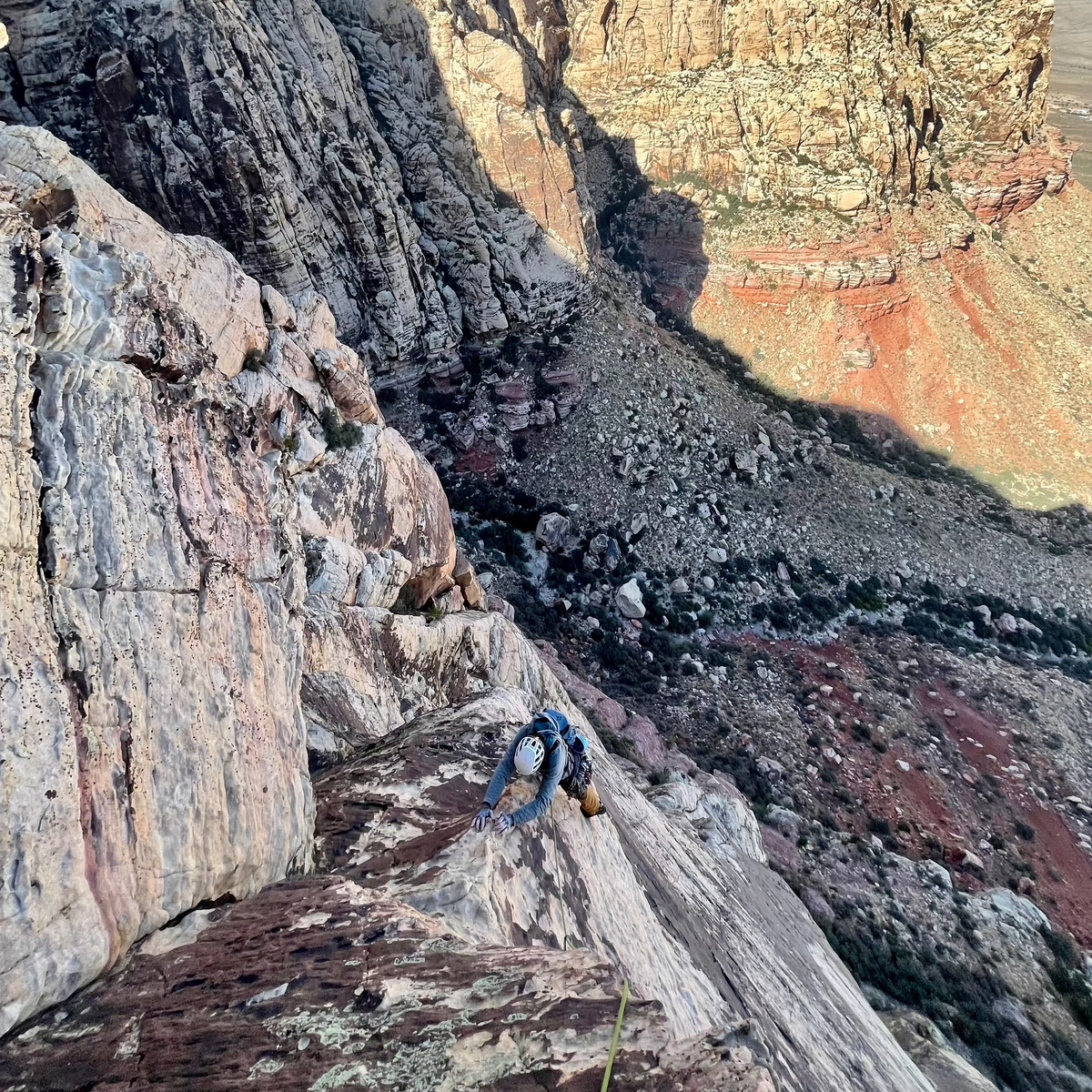 Climbers on a sandstone ridge high above the canyon at Red Rock, Nevada