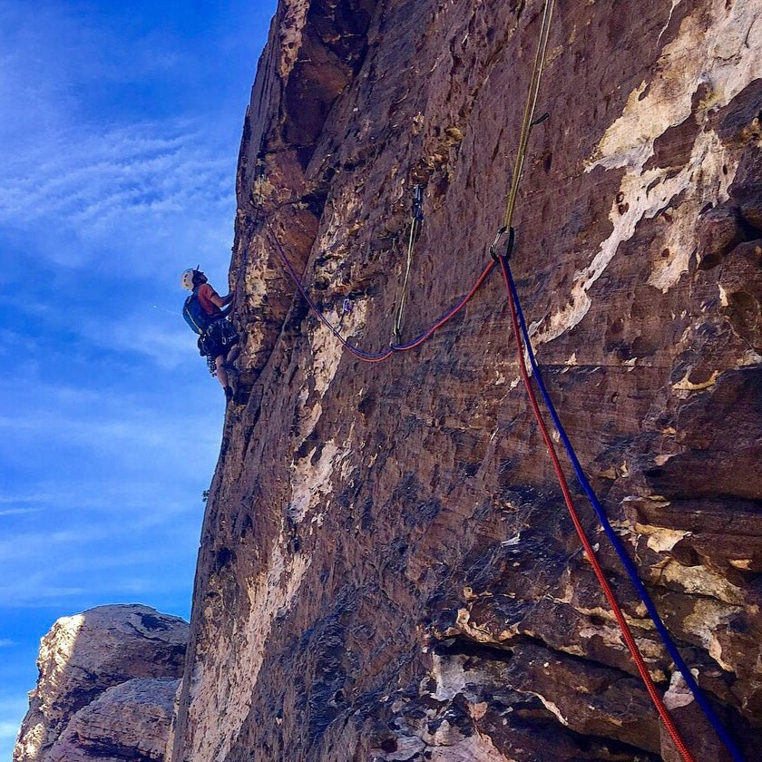 A climber leads a steep sandstone wall on a guided Red Rock Climbing Trip, Nevada