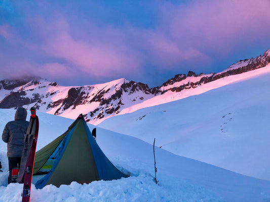 Setting up camp for the night on a glacier, appreciating the pink hughes of  the stunning alpenglow. 