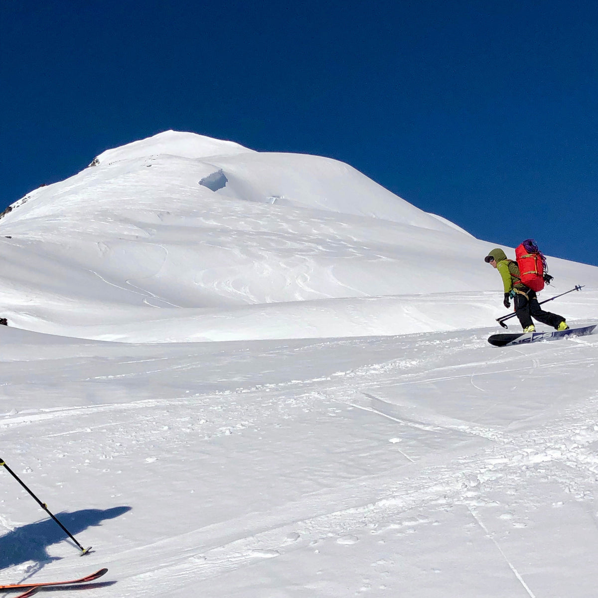 a splitboarder rides down the east face of eldorado peak and onto the inspiration glacier during Guided exposures forbidden tour with in north cascades national park in washington state