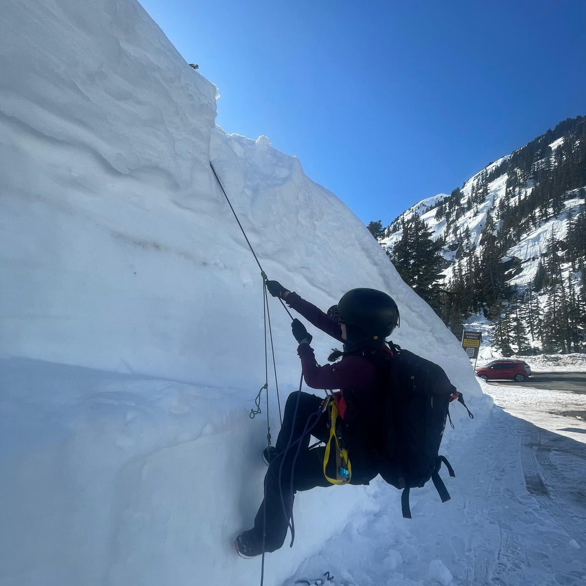 When re-ascending a rope, this student is using a foot loop and a prussik to make their way back up to their system from a vertical hanging position on a road cut. 