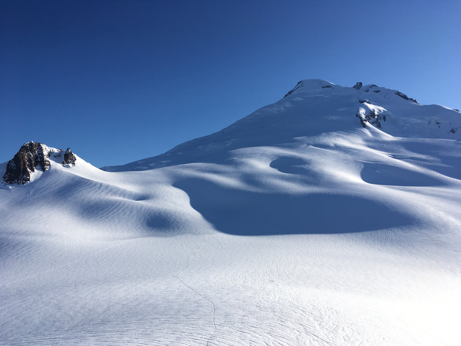 Ski tracks on the slopes of Mount Baker on a clear day. 