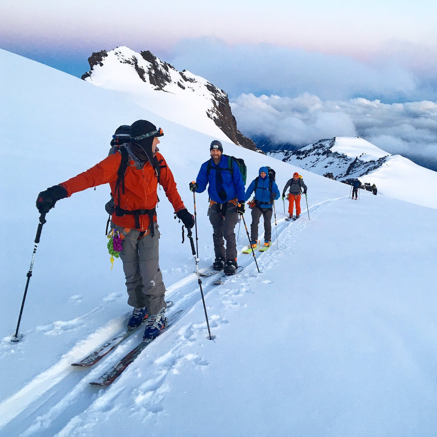 A group of skiers and splitboarders set a skin track on Mount Baker early in the morning. 
