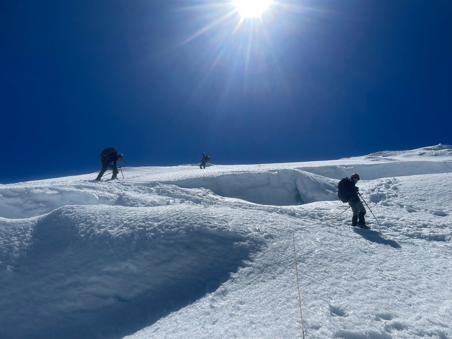 the team navigates through crevasses with a rope to protect an unexpected fall