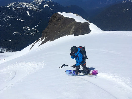 A woman makes splitboard turns on mount baker in the springtime