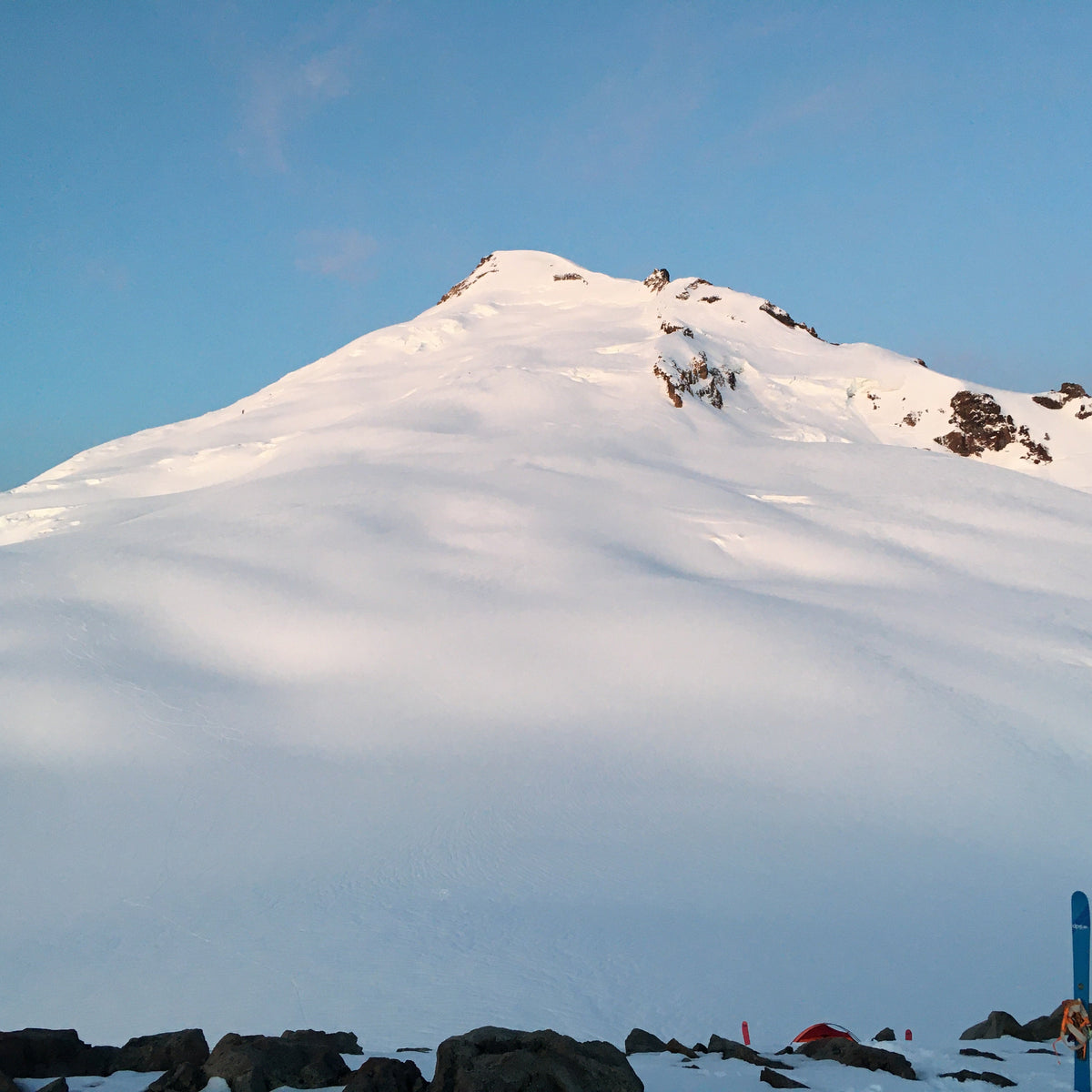 Snowy mountain peak mount baker with skis and poles at the base of the Park Glacier
