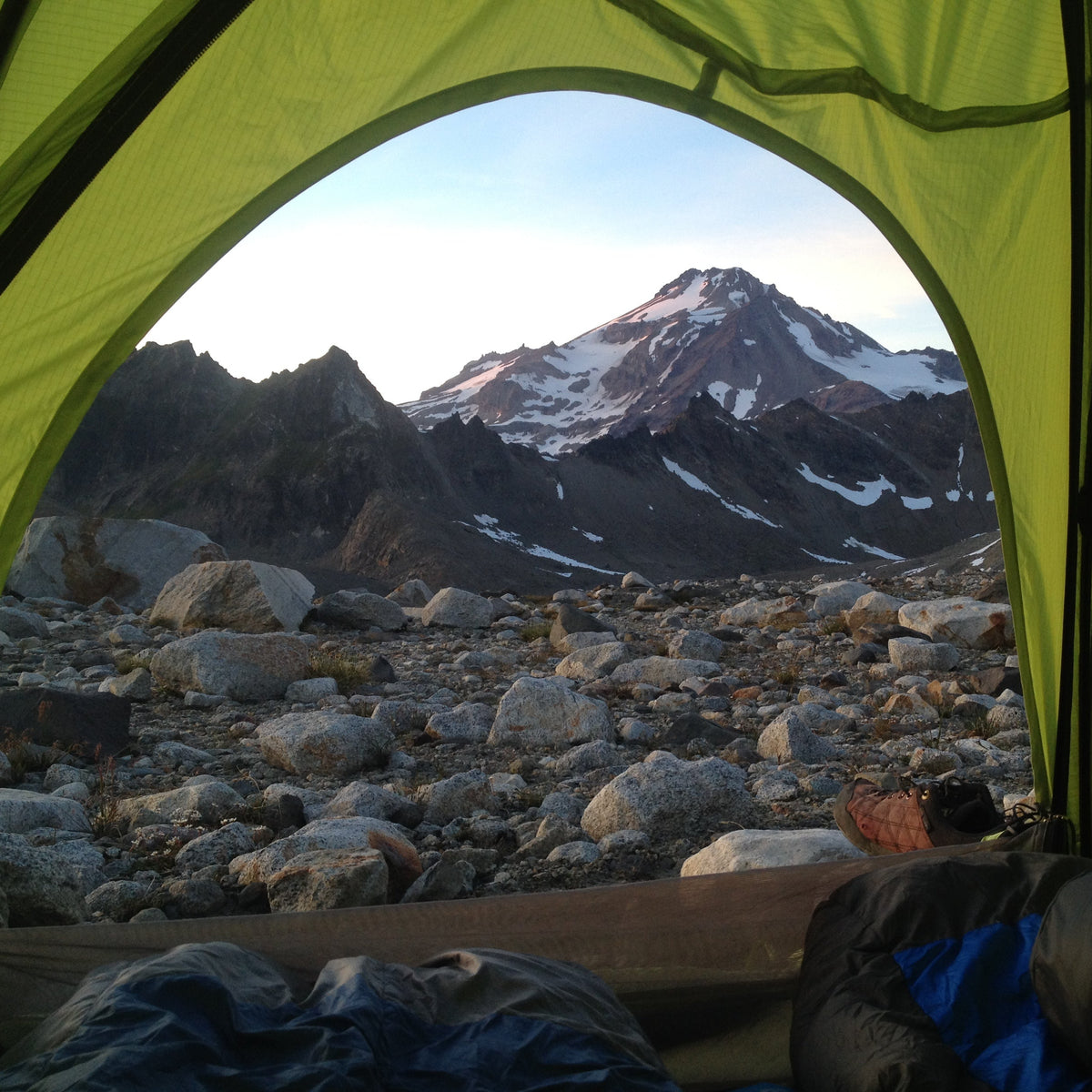 View of Glacier peak from inside a tent. a view of dakobed across the cool and chocolate glaciers