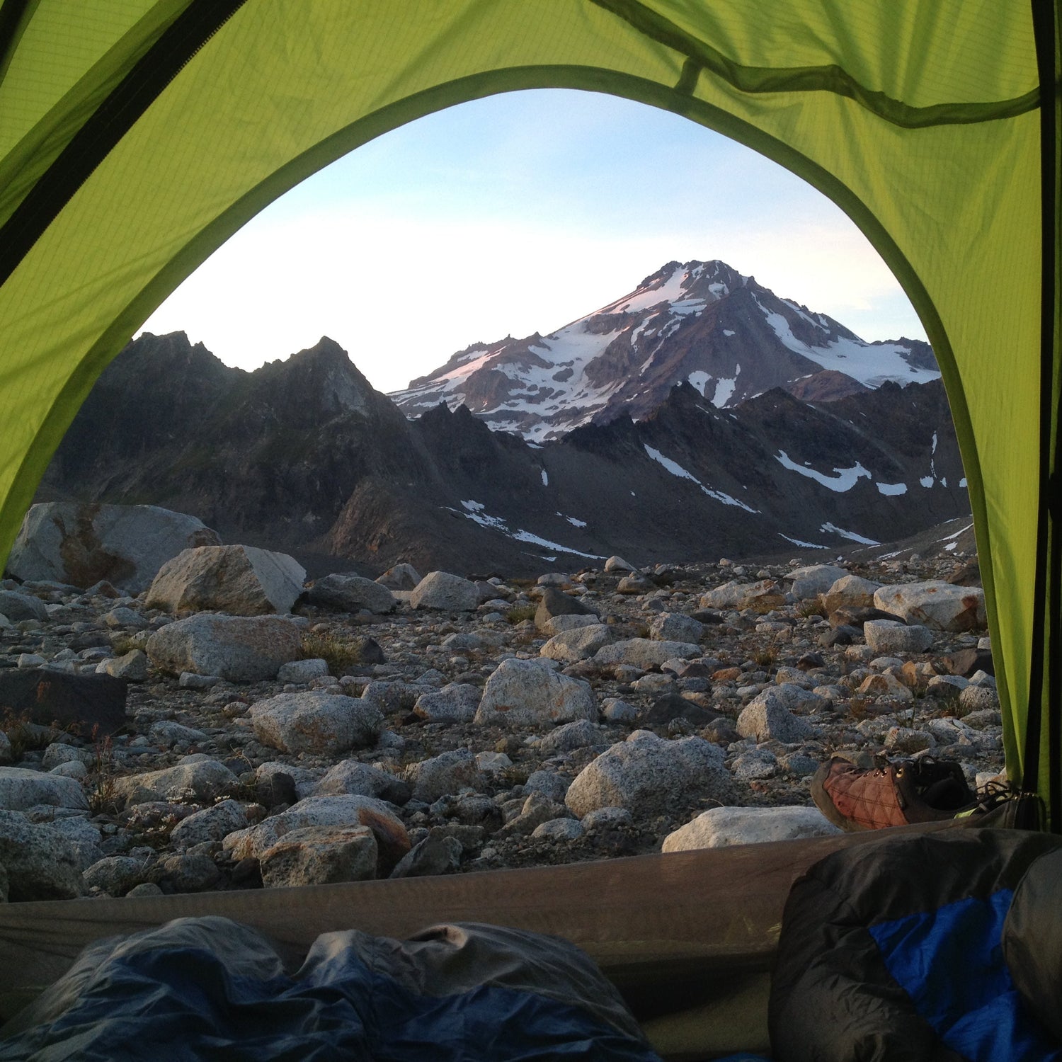 View of Glacier peak from inside a tent. a view of dakobed across the cool and chocolate glaciers