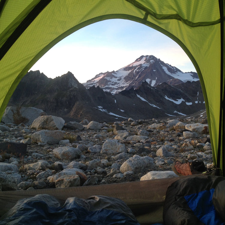 View of Glacier peak from inside a tent. a view of dakobed across the cool and chocolate glaciers