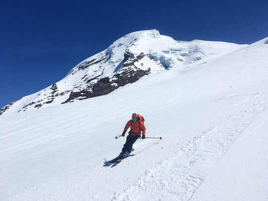 A skier enjoys sunshine and soft turns on the Coleman Glacier of Mount Baker.