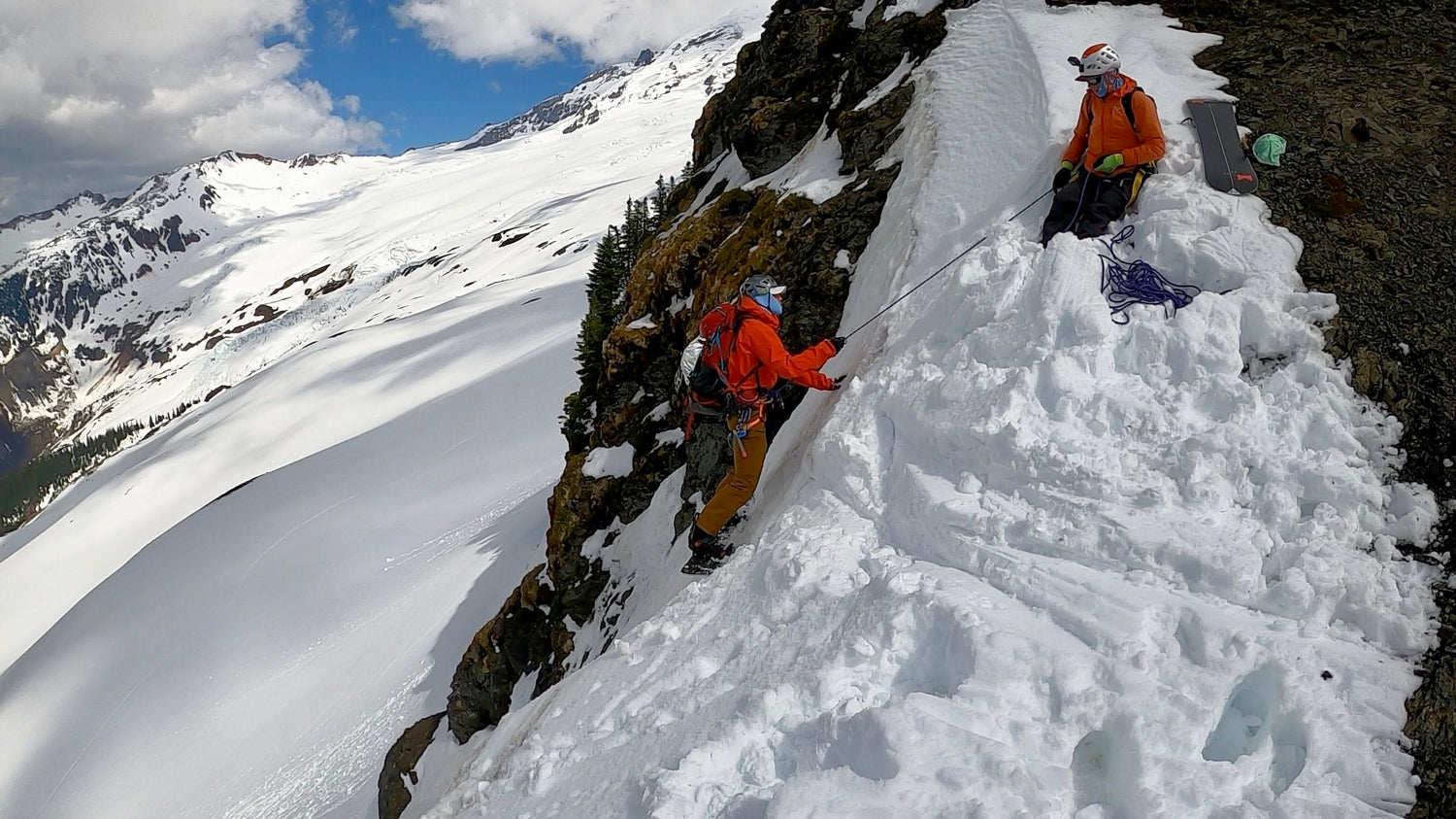 Lead guide and Founder of Guided Exposure belaying a guest into a steep couloir. 