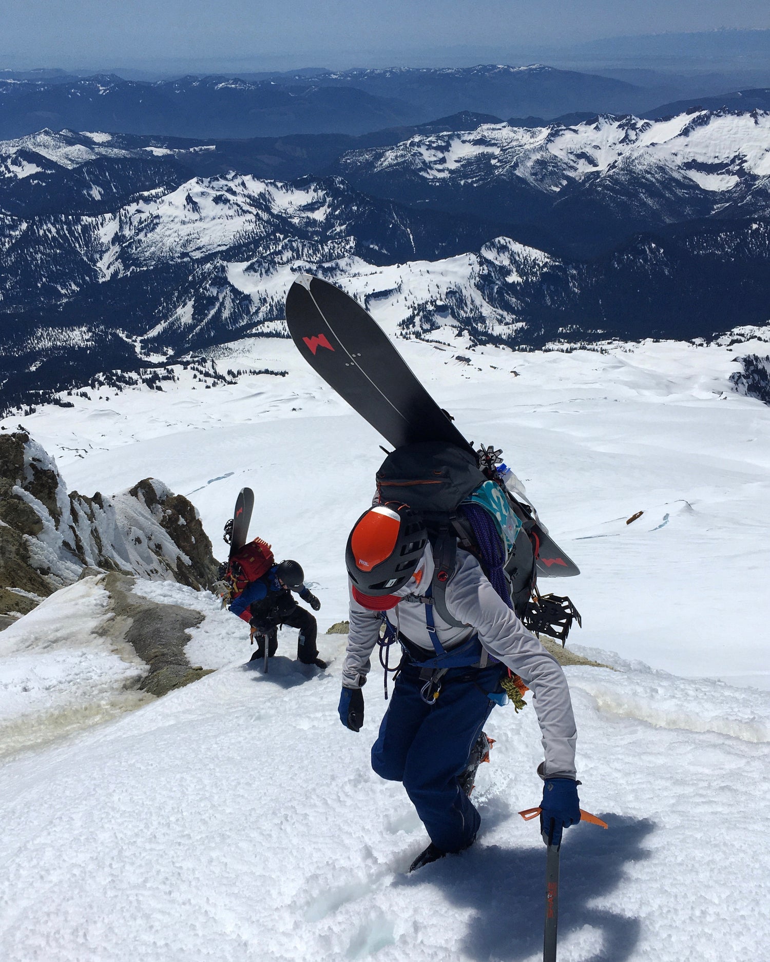Splitboarders are guided up Sherman Peak on Mount Baker  during a guided ski descent. Guided Exposure provides backcountry ski and splitboard guiding.