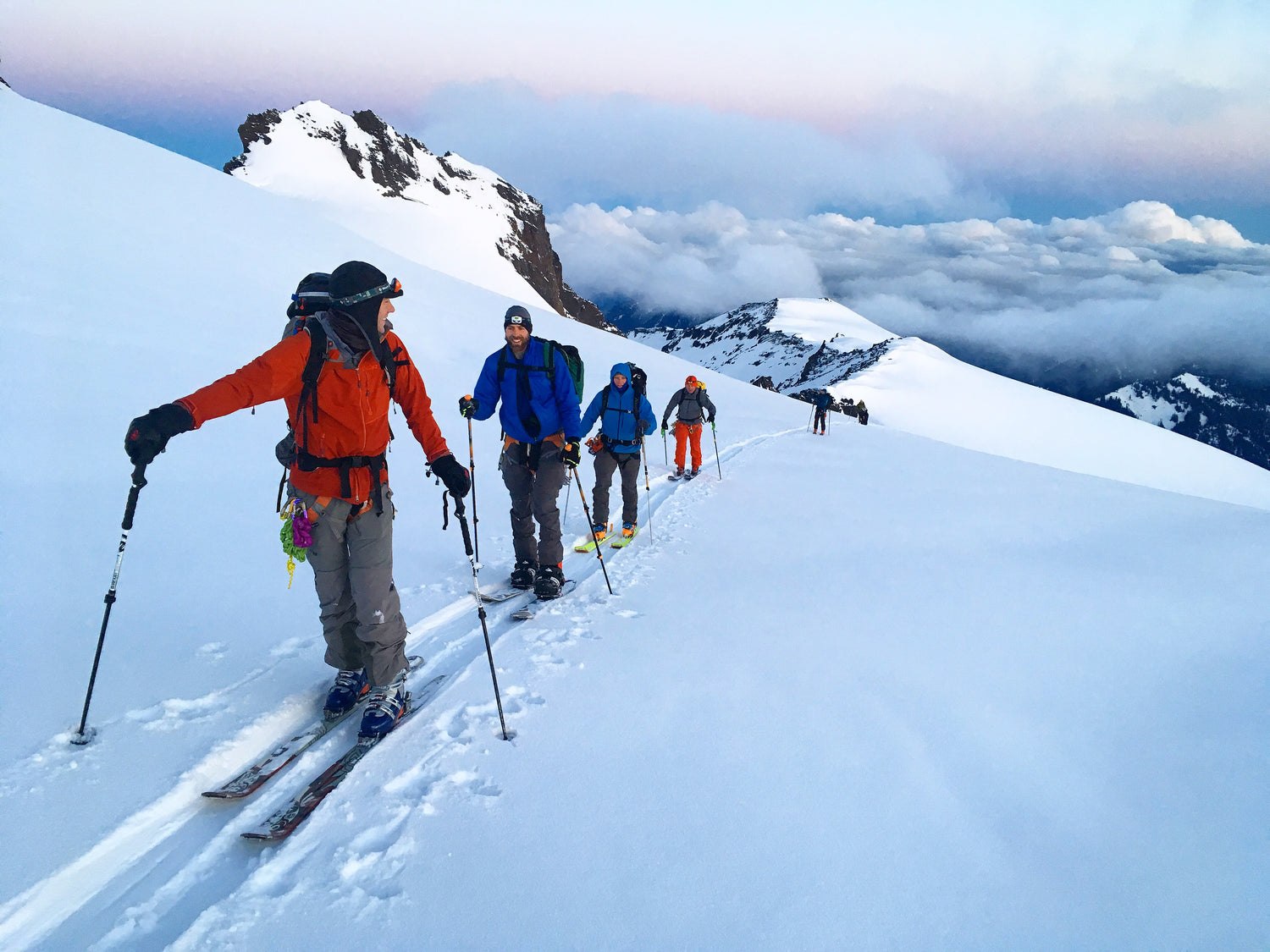 A group of skiers and splitboarders set a skin track on Mount Baker early in the morning. 