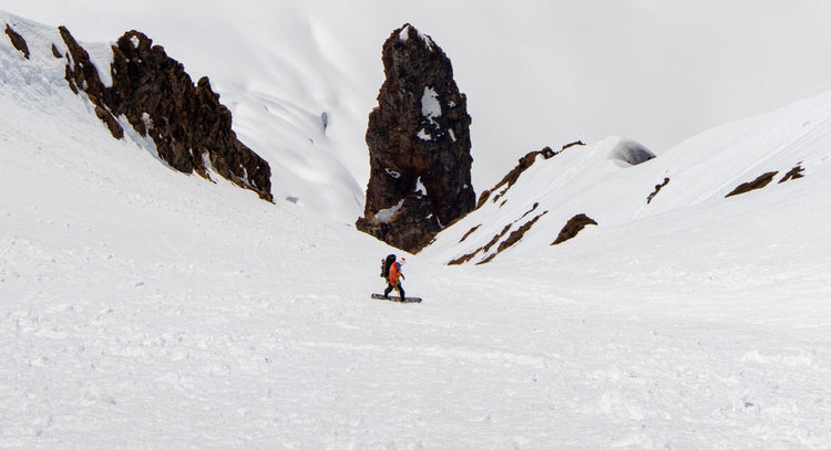 Splitboard Guide Jere Burrell descends the South Couloir on Colfax Peak on Mount Baker during a guided descent. 