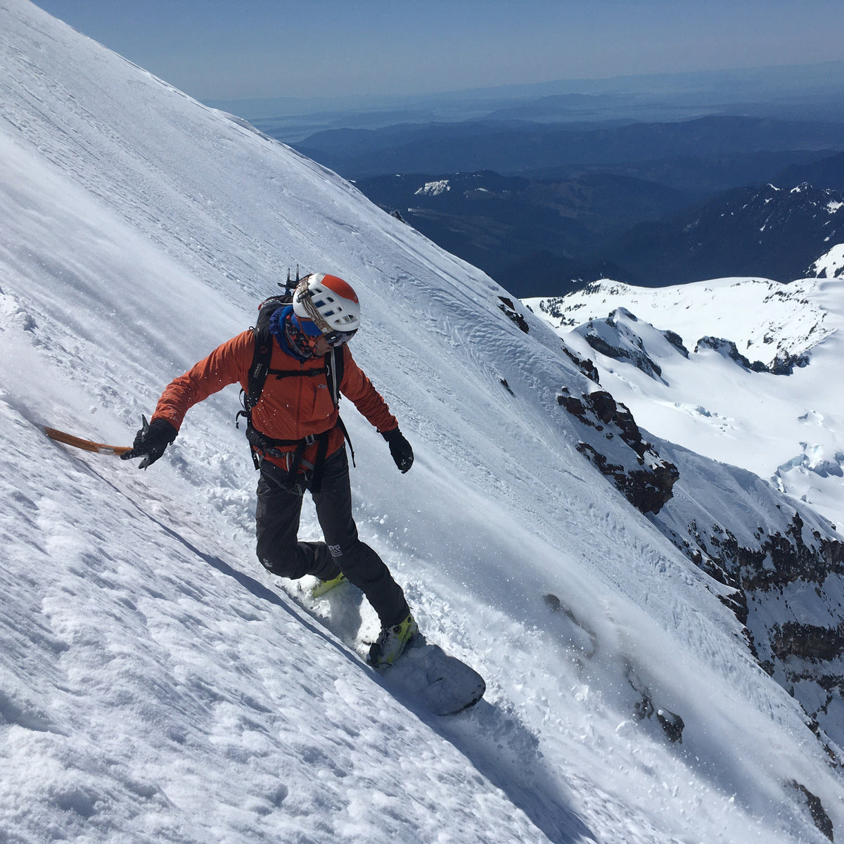 split boarding a steep mountain face on mount baker in Washington state. This volcano sees many ski and snowboard descents